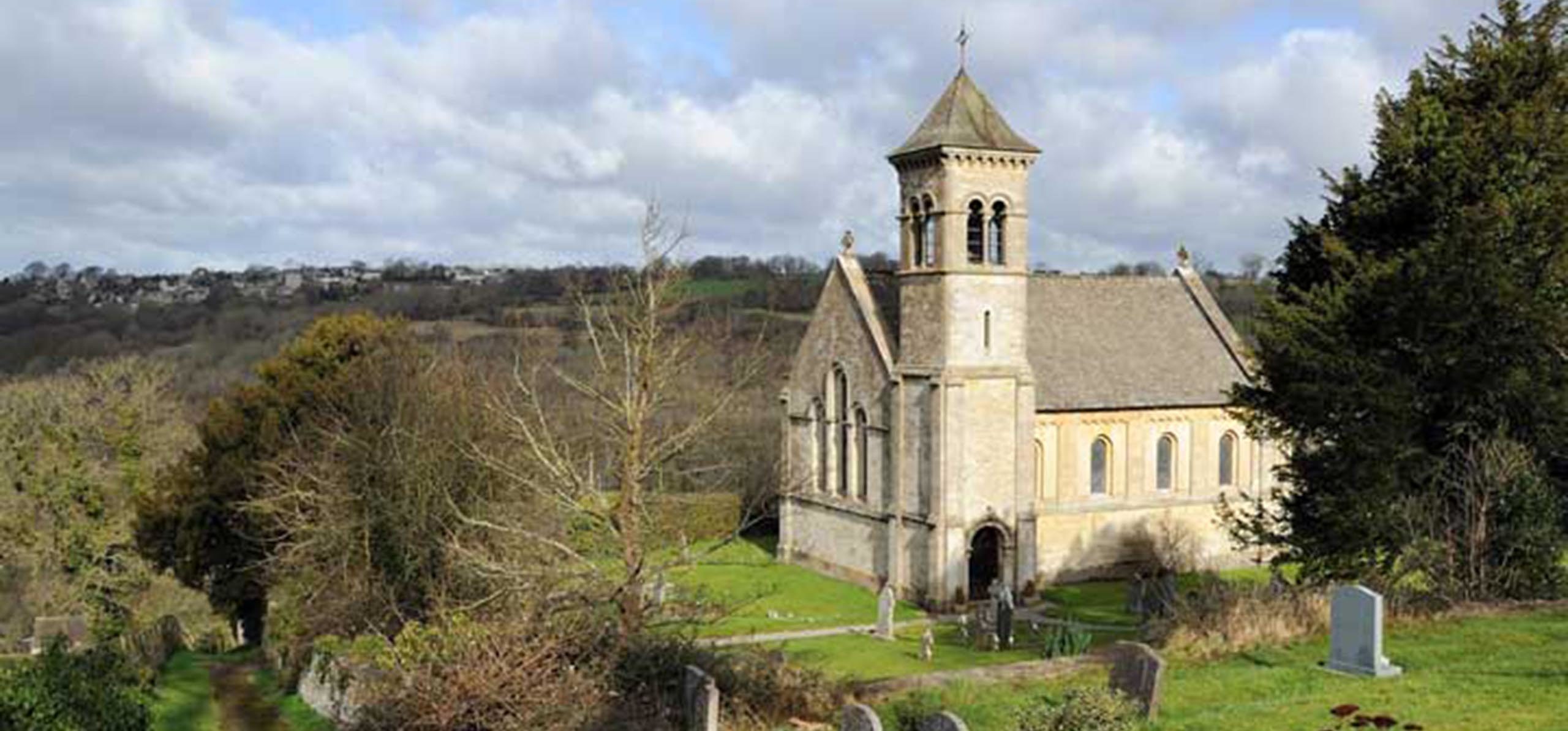 View of St Luke's Church in Frampton Mansell taken from the road above